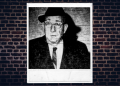Joseph Zammuto boss of Rockford Family wearing a fedora and top coat.