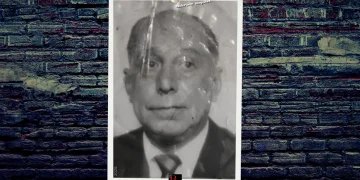 A mugshot of mobster Eugene Giannone featuring a pinned photograph on a brick background with the BG logo at the bottom.