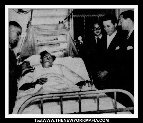 Danny Wags (second from right) is arraigned at the hospital bed of John Minutella.
