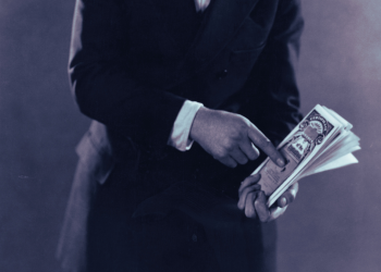 A man holding stock certificates.