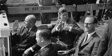 Robert Morgenthau rides in President John F. Kennedy's motor brigade.