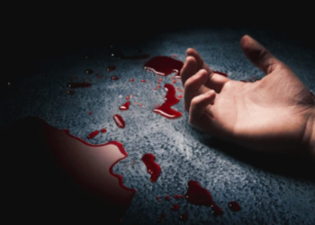 A photo showing an apparently dead person's hand in a pool of blood.