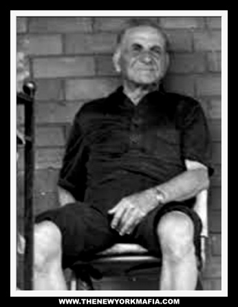 Playing his part well of an innocent elderly Italian man, Giacomo Luppino relaxes on the porch of his modest home.