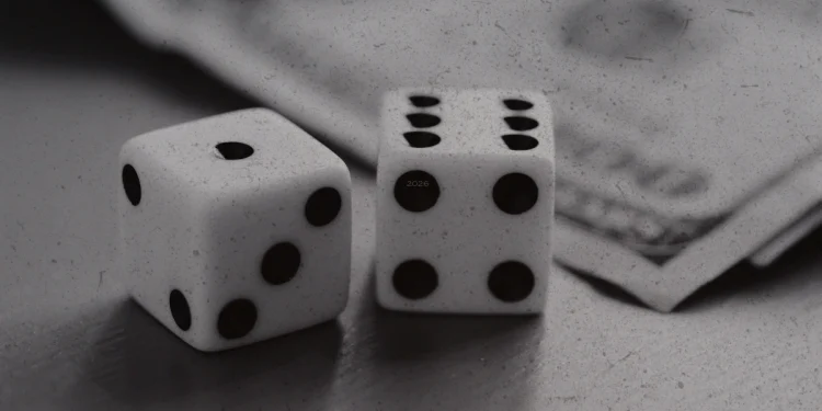A black and white photo of a pair of dice next to a stack of hundred dollar bills.